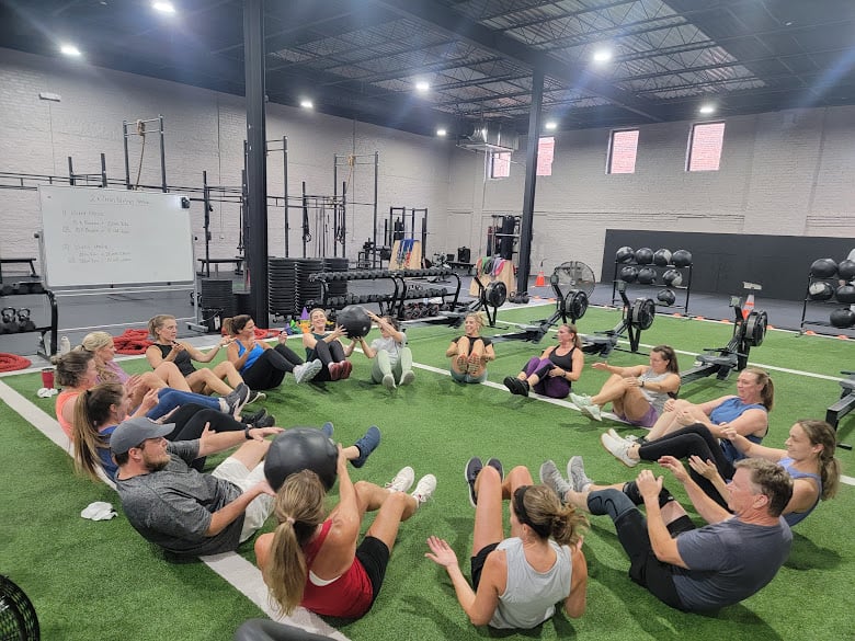 Adults of all fitness levels training together in a scalable group fitness class