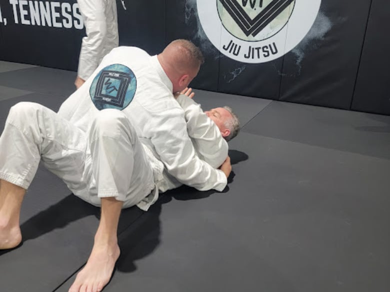 Adult jiu jitsu class training fundamentals on mats at Wild Tribe Academy