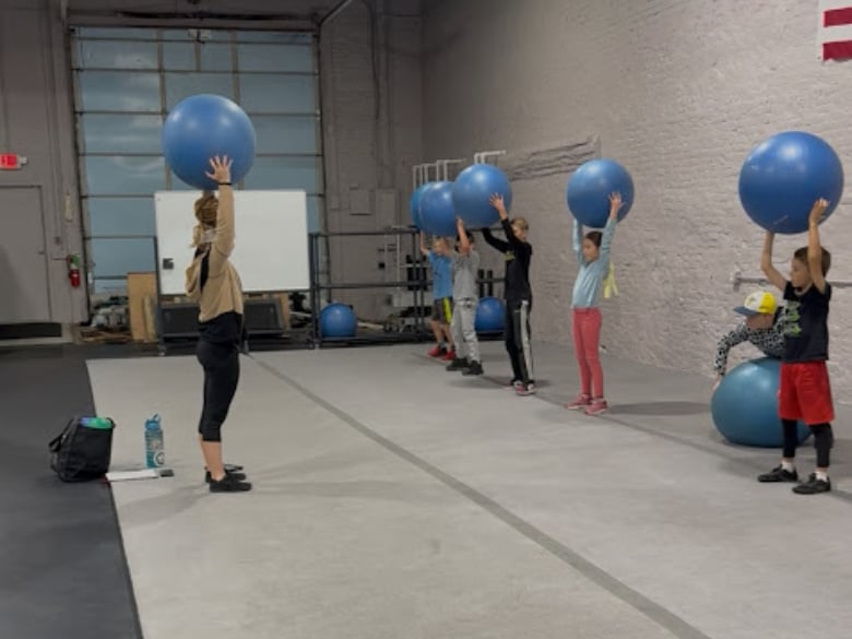 Kids playing movement-based games in a youth physical education class